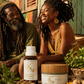 Two people sitting outdoors with a bottle and jar of Kiva Confections products.