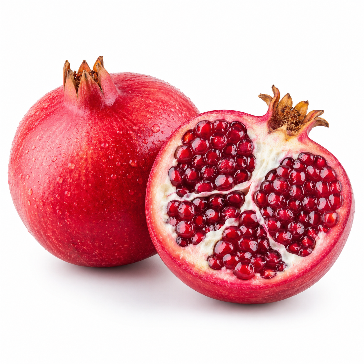 Pomegranate and half of a pomegranate on a white background